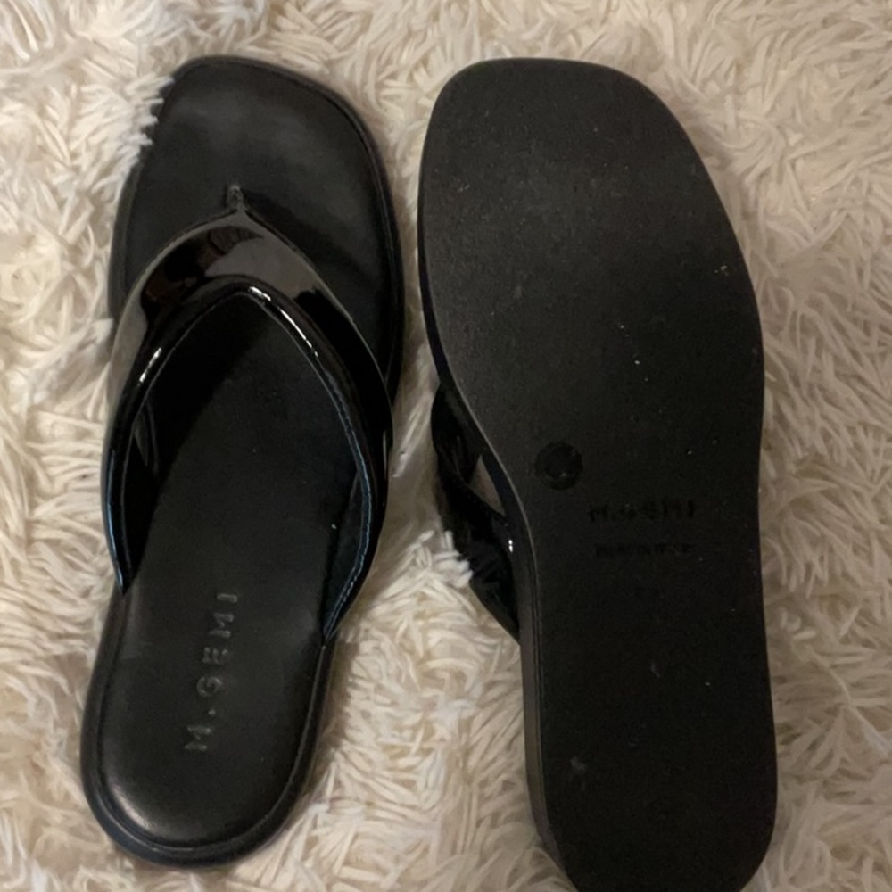 Leather and patent leather flipflop sandals.Barely worn.No scuffs. Sole perfect